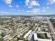 Scenic aerial view capturing residential area with a pond, and glimpses of bay and bridges at 9945 47Th N Ave # 206, St Petersburg, FL 33708