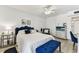 Bedroom with a blue headboard, ceiling fan and two nightstands at 9945 47Th N Ave # 206, St Petersburg, FL 33708