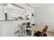 Cozy dining area featuring a round table and seating for four, adjacent to a bright, updated kitchen at 9945 47Th N Ave # 206, St Petersburg, FL 33708