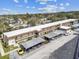 A condo building's exterior elevation with covered parking and lush landscaping at 9945 47Th N Ave # 206, St Petersburg, FL 33708