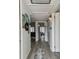 Inviting hallway with textured walls and wood-look floors leading to the living area at 9945 47Th N Ave # 206, St Petersburg, FL 33708