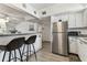 Bright kitchen featuring a breakfast bar, stainless steel appliances, and ample cabinet space at 9945 47Th N Ave # 206, St Petersburg, FL 33708