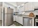 Well-lit kitchen with stainless steel appliances, ample cabinet space, and contemporary countertops at 9945 47Th N Ave # 206, St Petersburg, FL 33708