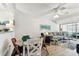 Cozy condo living room featuring a ceiling fan, comfy seating, and bright natural light at 9945 47Th N Ave # 206, St Petersburg, FL 33708