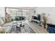 Comfortable living room featuring stylish furnishings, neutral colors, and access to a bright sunroom at 9945 47Th N Ave # 206, St Petersburg, FL 33708