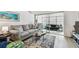Bright living room featuring a comfortable sofa, a unique coffee table, and a sunroom at 9945 47Th N Ave # 206, St Petersburg, FL 33708