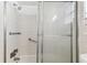 Shower featuring white tiles, grab bars, and glass door at 9945 47Th N Ave # 206, St Petersburg, FL 33708