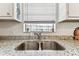 Modern kitchen sink with stylish faucet and granite countertop, offering both functionality and elegance at 9945 47Th N Ave # 206, St Petersburg, FL 33708