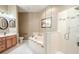 Elegant bathroom with double vanity, soaking tub, and walk-in shower at 10632 Ashford Oaks Dr, Tampa, FL 33625