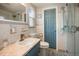 Updated bathroom with a blue vanity and walk-in shower at 10941 Oakdale Ave, Port Richey, FL 34668