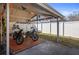Covered carport with space for motorcycles at 10941 Oakdale Ave, Port Richey, FL 34668