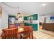 Bright dining area with kitchen view and wood table at 10941 Oakdale Ave, Port Richey, FL 34668