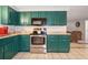 Kitchen features stainless steel appliances and green cabinets at 10941 Oakdale Ave, Port Richey, FL 34668
