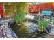 Tranquil backyard pond with a small fountain, surrounded by lush greenery at 10941 Oakdale Ave, Port Richey, FL 34668