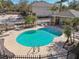 Community pool with a covered patio and lounge chairs at 1115 Andrew Aviles Cir, Tampa, FL 33619