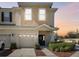 Two-story townhome with a two-car garage at dusk at 1115 Andrew Aviles Cir, Tampa, FL 33619