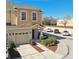 Two-story tan townhome with a two-car garage and nicely landscaped front at 1115 Andrew Aviles Cir, Tampa, FL 33619