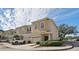Two-story tan townhome with two-car garage and attractive landscaping at 1115 Andrew Aviles Cir, Tampa, FL 33619