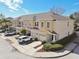 Tan three-story townhome with two-car garage and landscaped front yard at 1115 Andrew Aviles Cir, Tampa, FL 33619