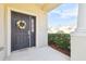 Dark-stained front door with a pretty floral wreath at 1115 Andrew Aviles Cir, Tampa, FL 33619