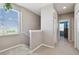 Upstairs hallway with carpet, window, and bedroom access at 1115 Andrew Aviles Cir, Tampa, FL 33619