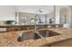 Modern kitchen sink with granite countertops and a stainless steel faucet at 1115 Andrew Aviles Cir, Tampa, FL 33619