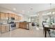 Open concept kitchen and dining area with hardwood floors and chandelier at 1115 Andrew Aviles Cir, Tampa, FL 33619