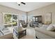 Living room with gray sofas, recliner, and sliding glass door at 1115 Andrew Aviles Cir, Tampa, FL 33619