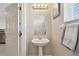 Guest bathroom featuring a pedestal sink and mirrored vanity at 1115 Andrew Aviles Cir, Tampa, FL 33619