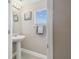 Small powder room with pedestal sink and white tile floor at 1115 Andrew Aviles Cir, Tampa, FL 33619