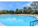 Large community swimming pool with lounge chairs at 11740 New Britain Dr, Spring Hill, FL 34609