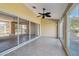 Spacious screened-in porch with ceiling fan and view of water at 12207 Arron Ter, Trinity, FL 34655