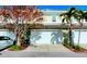Townhouse exterior with white garage door and landscaping at 1275 Drew St, Clearwater, FL 33755