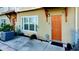Inviting front entrance of townhome with orange door and landscaping at 1275 Drew St, Clearwater, FL 33755