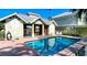 Community pool with seating area and adjacent clubhouse at 1275 Drew St, Clearwater, FL 33755
