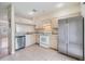 Bright kitchen with stainless steel appliances and light wood cabinets at 1308 Costa Mesa Dr, Wesley Chapel, FL 33543