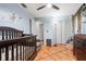 bedroom with a crib and hardwood floors at 13215 Parkhurst Ct, Riverview, FL 33569