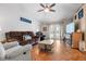 Bright living room with hardwood floors, comfy seating, and a large TV at 13215 Parkhurst Ct, Riverview, FL 33569