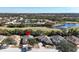 Aerial view of the home in a lakeside community surrounded by lush landscaping at 1330 Misty Greens Dr, Sun City Center, FL 33573