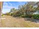 Lush backyard with mature trees and vegetation providing shade and privacy at 1330 Misty Greens Dr, Sun City Center, FL 33573