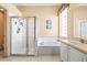 Bright bathroom featuring a walk-in shower and a soaking tub under a window at 1330 Misty Greens Dr, Sun City Center, FL 33573