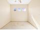 Bright bedroom featuring neutral carpeting, ceiling fan, and a bank of three windows at 1330 Misty Greens Dr, Sun City Center, FL 33573