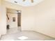 Cozy bedroom showcasing neutral carpeting and an open doorway to the home's tile flooring at 1330 Misty Greens Dr, Sun City Center, FL 33573