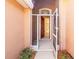 Front entrance with screen and solid doors leading inside at 1330 Misty Greens Dr, Sun City Center, FL 33573