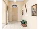 Light-filled hallway with tile flooring and wall decor at 1330 Misty Greens Dr, Sun City Center, FL 33573