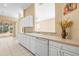 Kitchen counter overlooking a spacious living area, white appliances, and a sliding door to the yard at 1330 Misty Greens Dr, Sun City Center, FL 33573