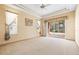 Spacious main bedroom features neutral walls, carpet, and a sliding glass door to the outside at 1330 Misty Greens Dr, Sun City Center, FL 33573