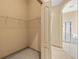 Walk-in closet showing door opening to another bathroom featuring soaking tub and shower at 1330 Misty Greens Dr, Sun City Center, FL 33573