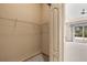 Walk-in closet with wire shelving and neutral carpeting leading to a bedroom at 1330 Misty Greens Dr, Sun City Center, FL 33573