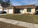 Quaint one-story home showcasing a brown roof and well-kept lawn at 1915 Crown Park Dr, Valrico, FL 33594